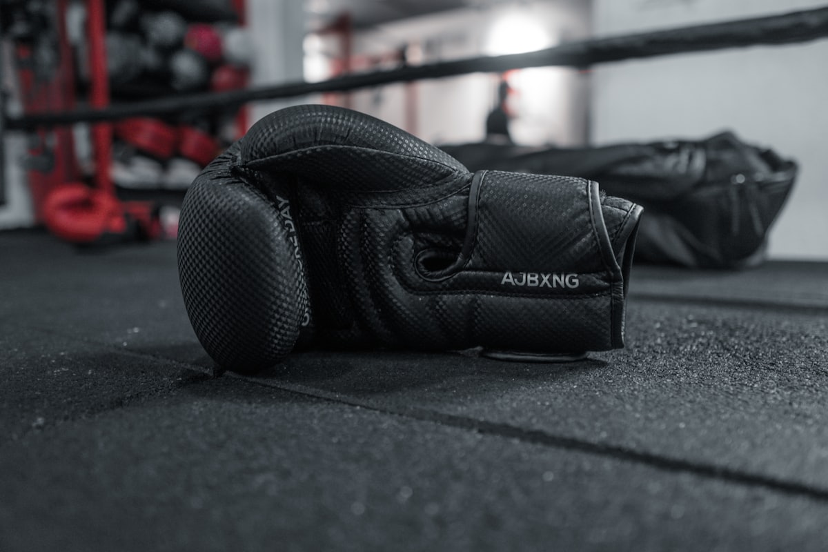 Boxing gloves resting on the gym floor