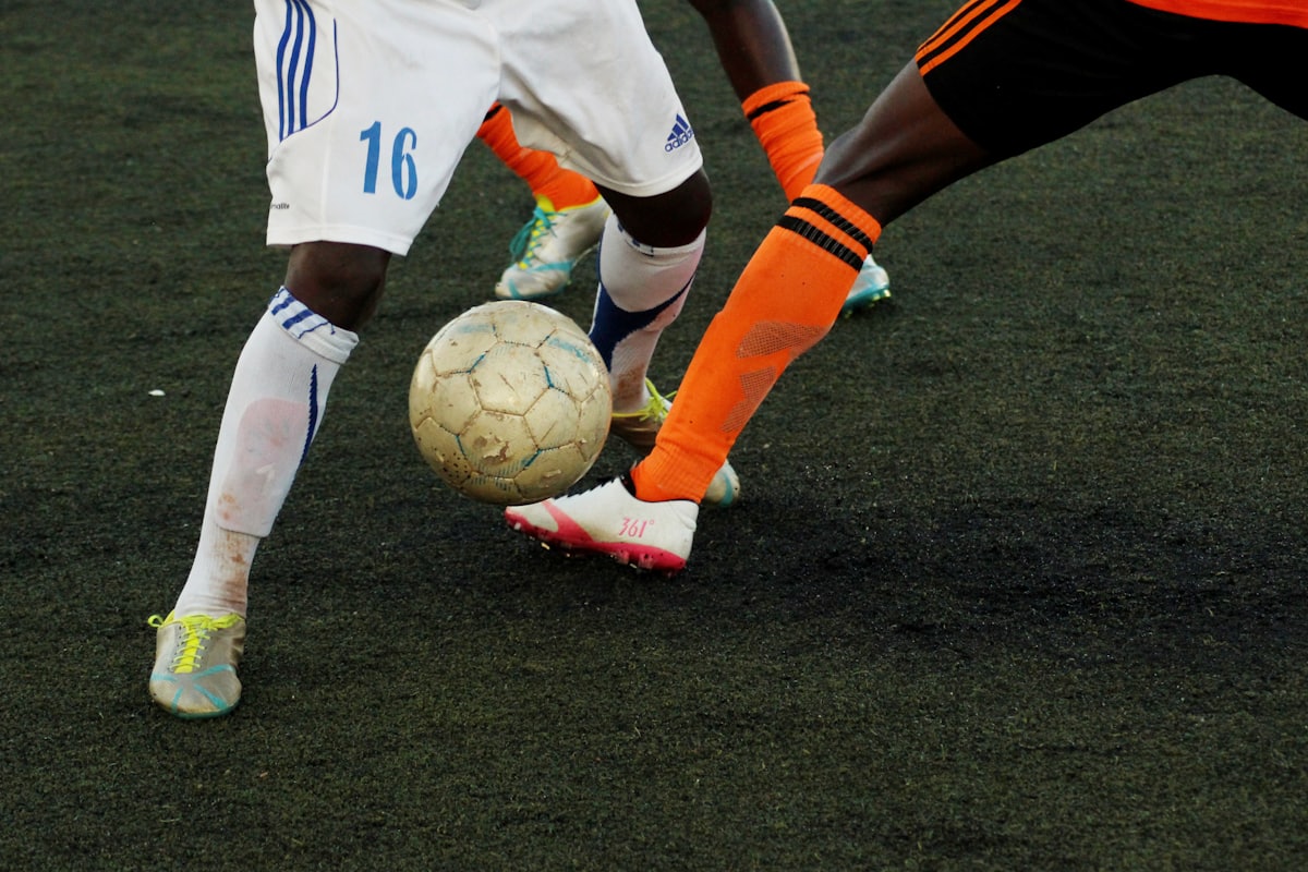 Football players challenging for the ball during a live match